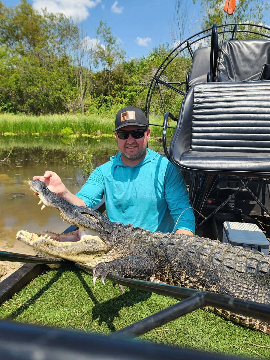 Hunter with a harvested alligator