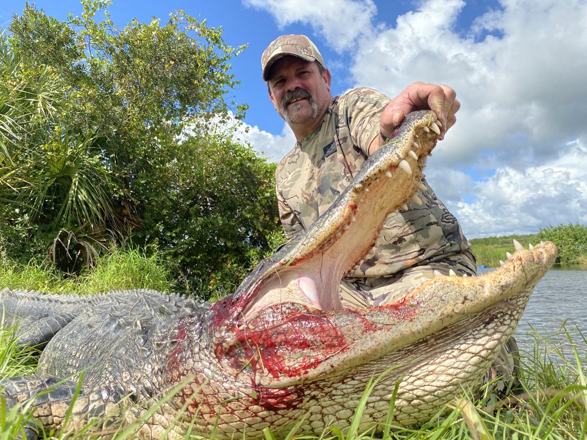 Hunter with a harvested alligator