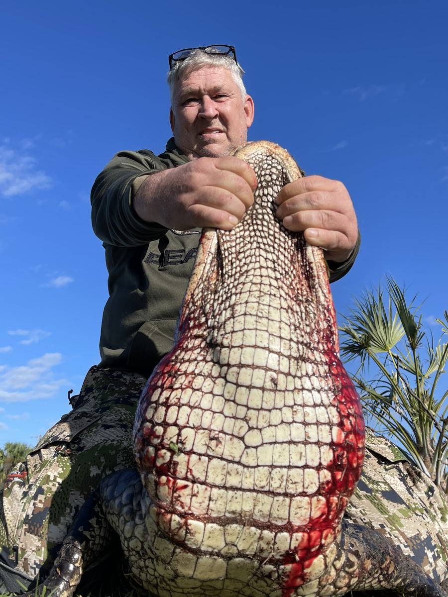 Hunter with a harvested alligator