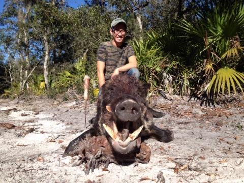 Hunter with a harvested wild hog