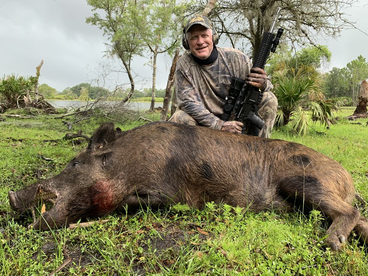Hunter with a harvested wild hog