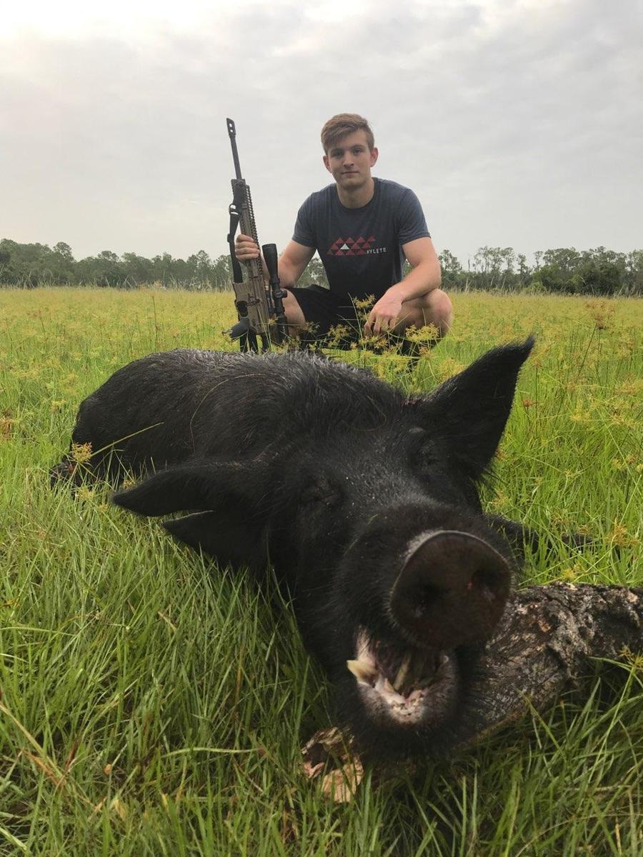 Hunter with a harvested wild hog
