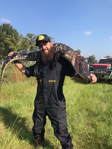 Hunter with a harvested wild hog