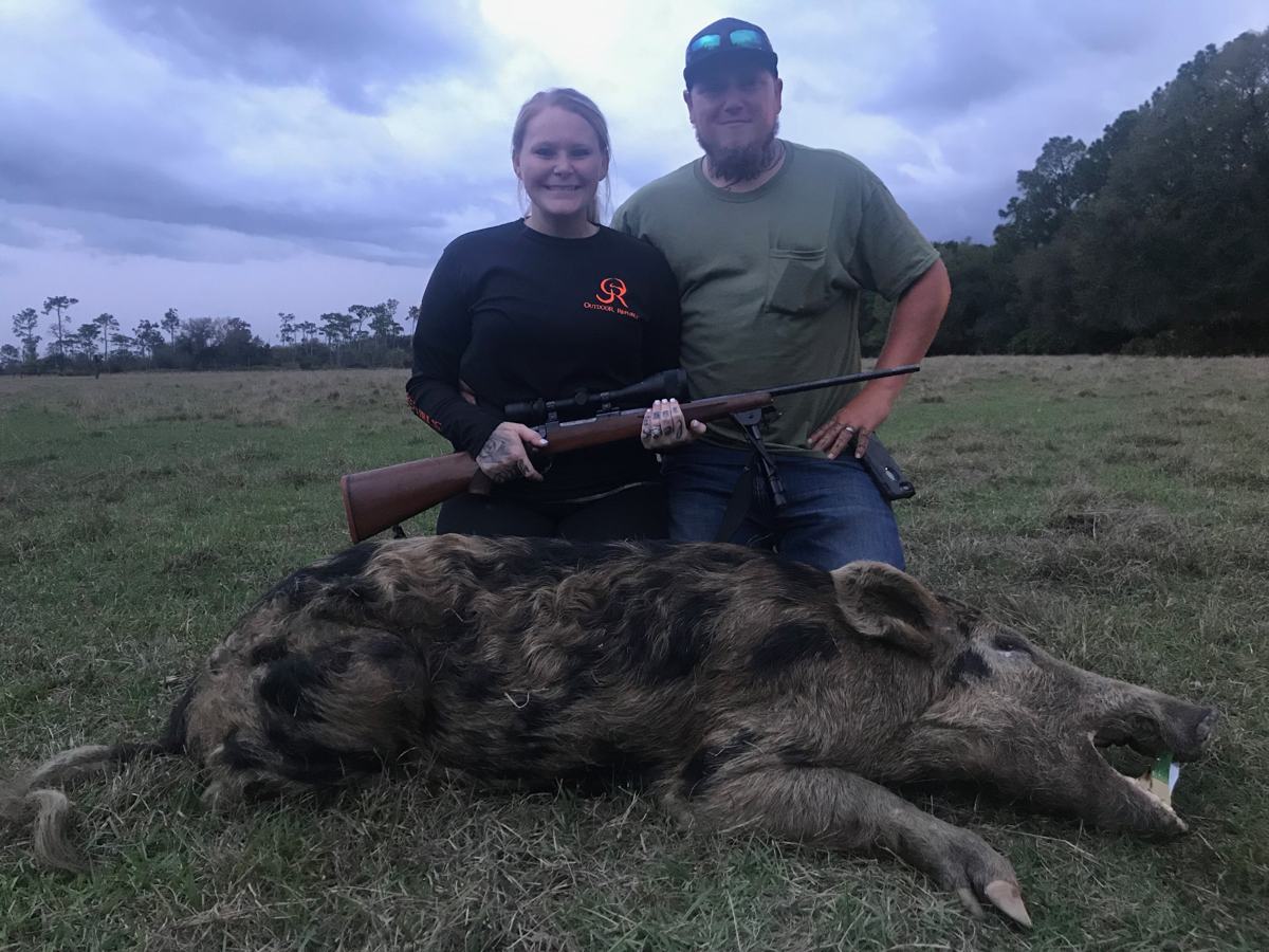 Hunter with a harvested wild hog