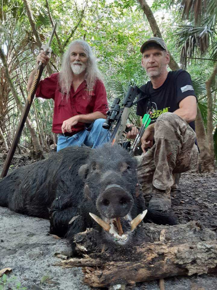 Hunter with a harvested wild hog