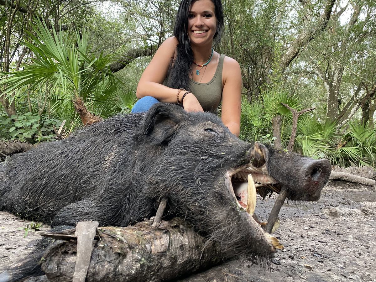 Hunter with a harvested wild hog