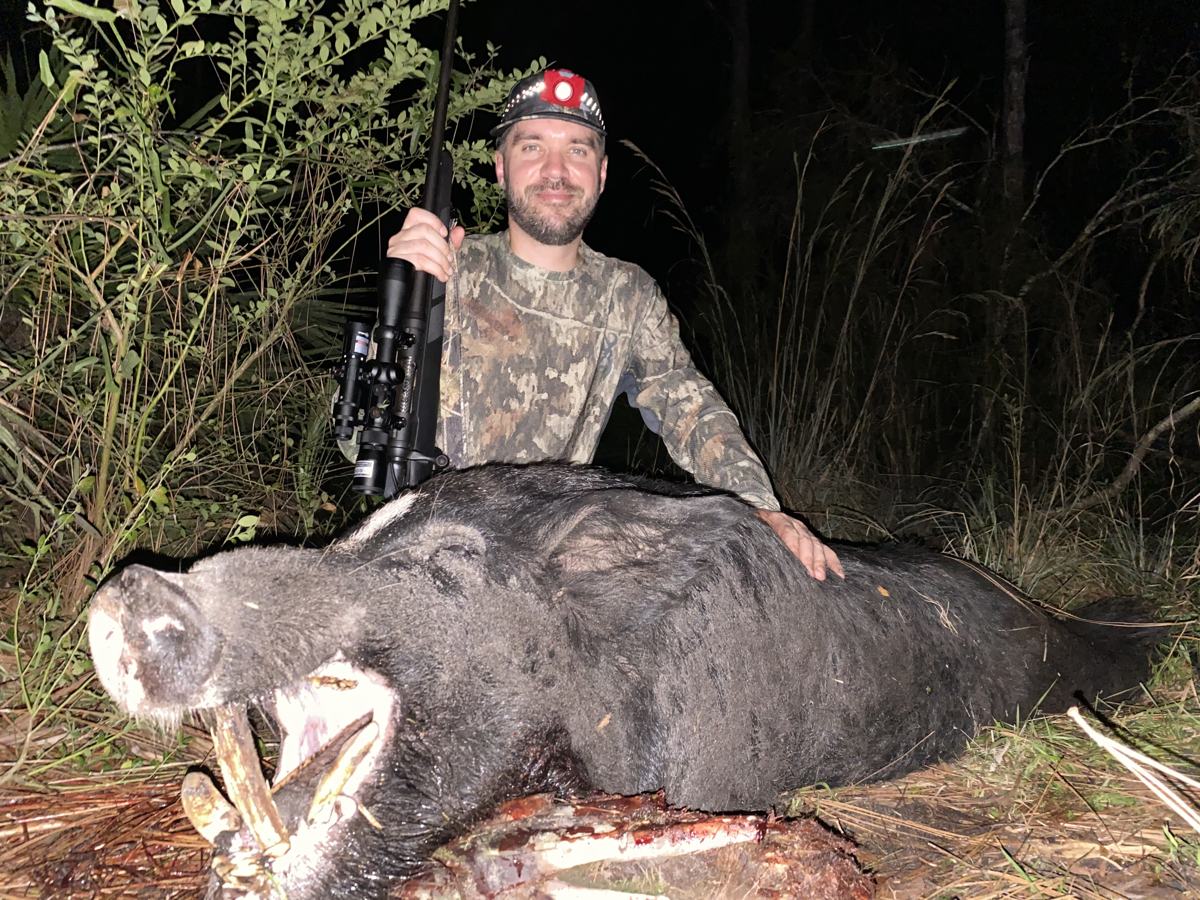 Hunter with a harvested wild hog
