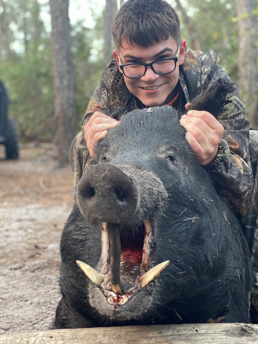 Hunter with a harvested wild hog
