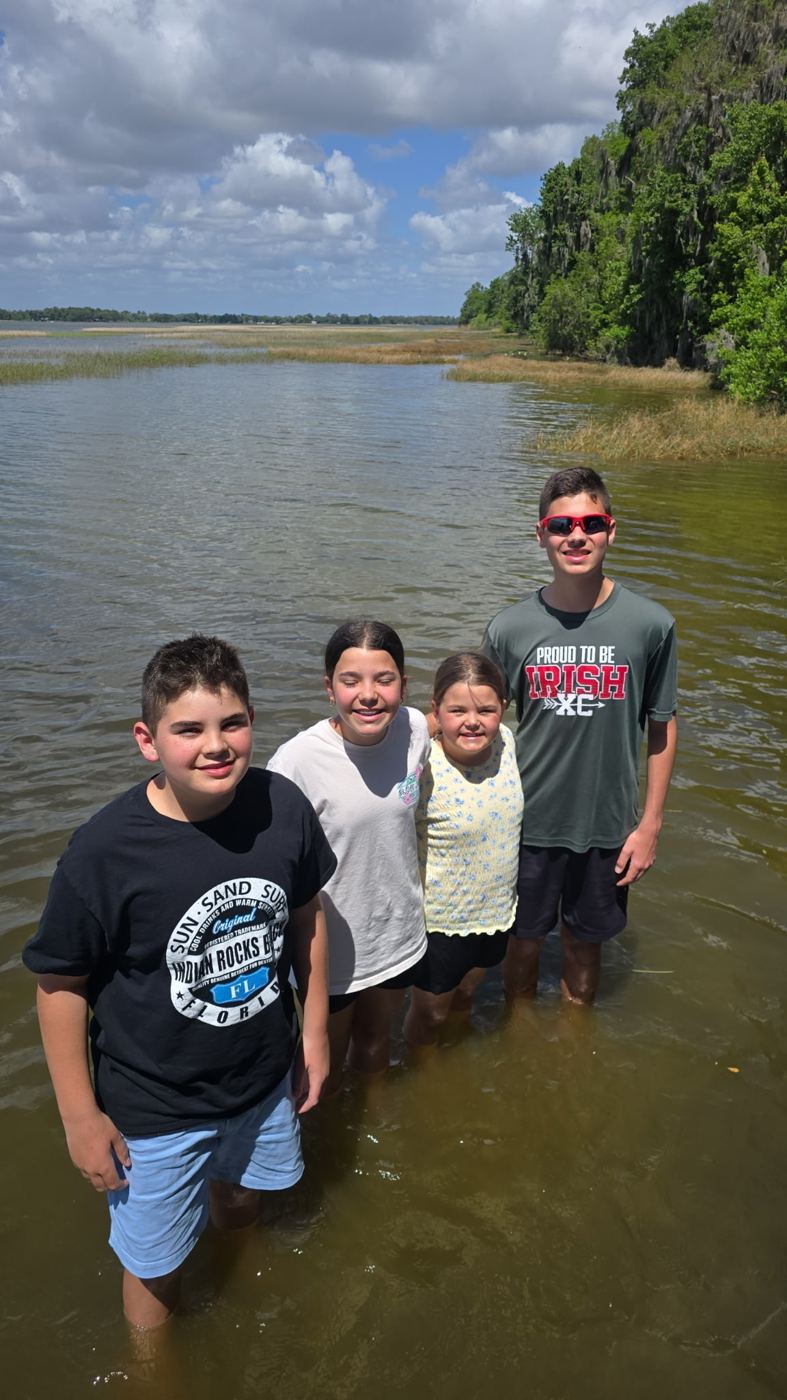 Kids standing in the shallows