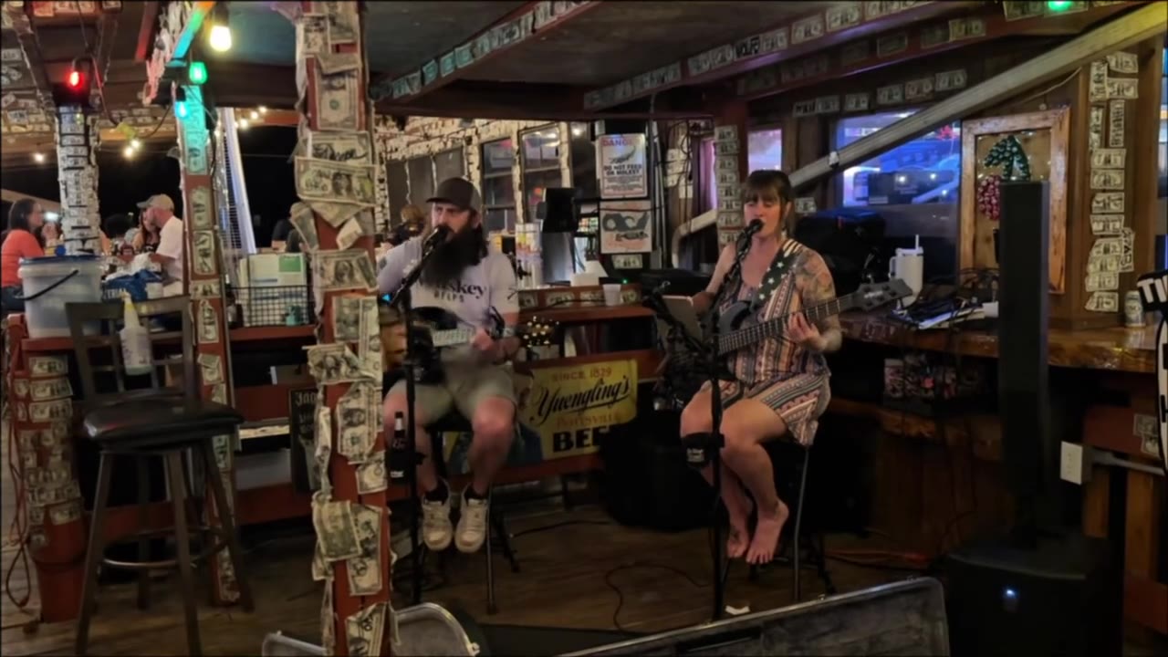 Live music inside Cherry Pocket, with dollar bills covering the posts